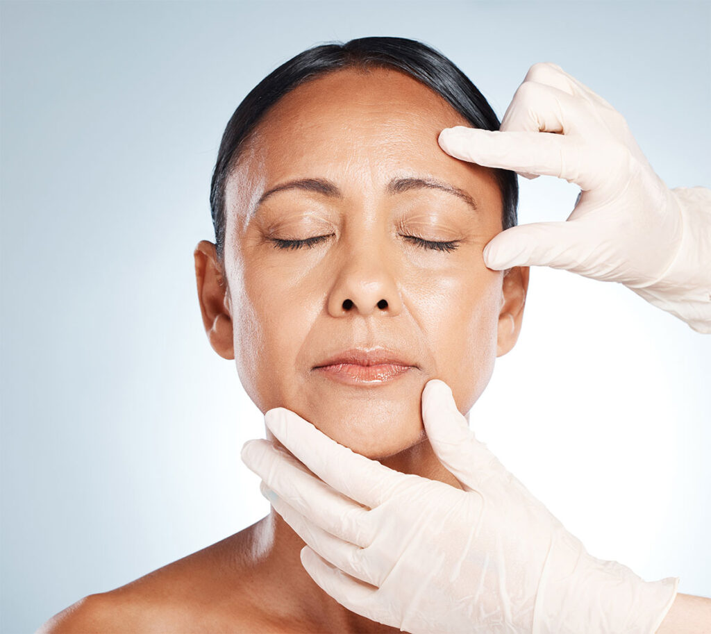 Woman with closed eyes having face inspected